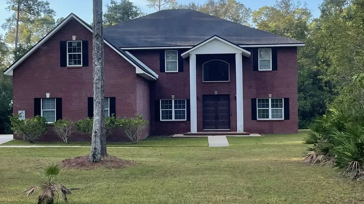 Two-storey St. Augustine home with clean brick and siding after exterior washing