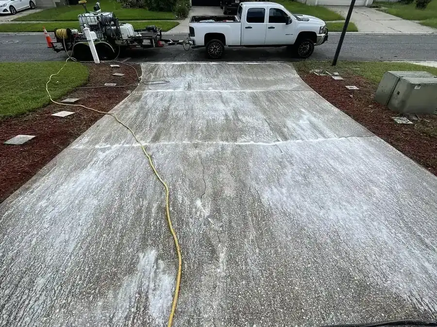 Cannon truck and pressure washing rig set up on a residential driveway job