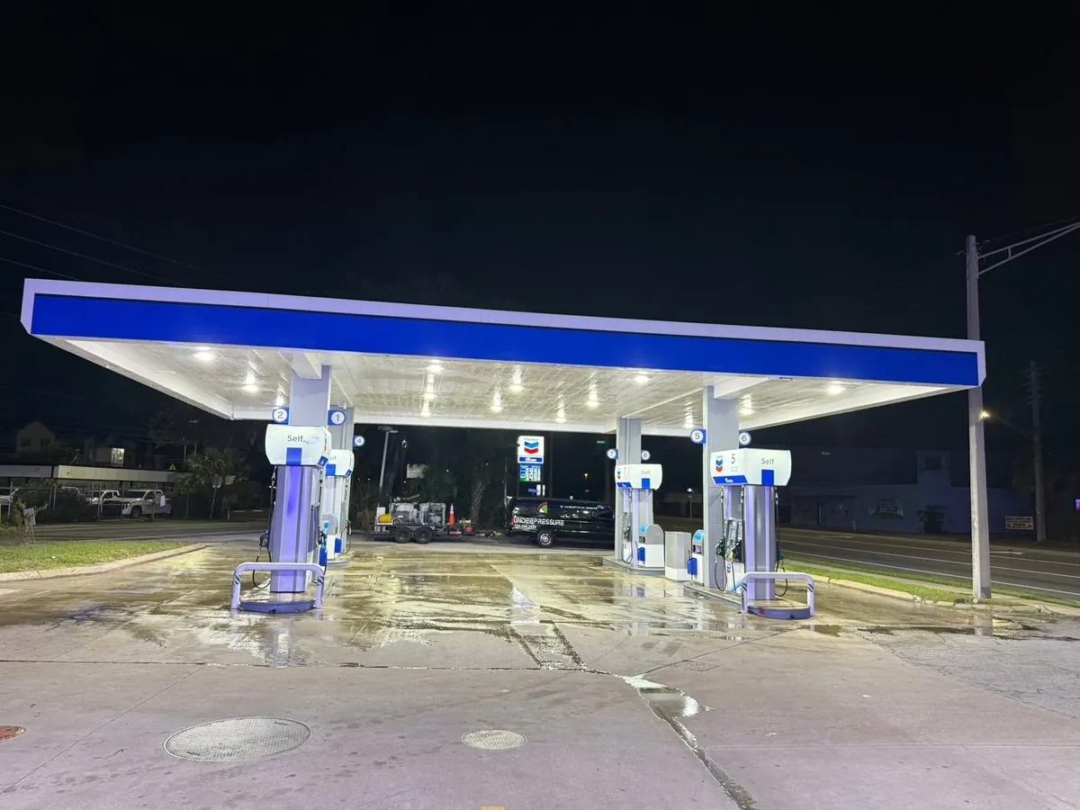 Gas station forecourt and canopy after commercial pressure washing