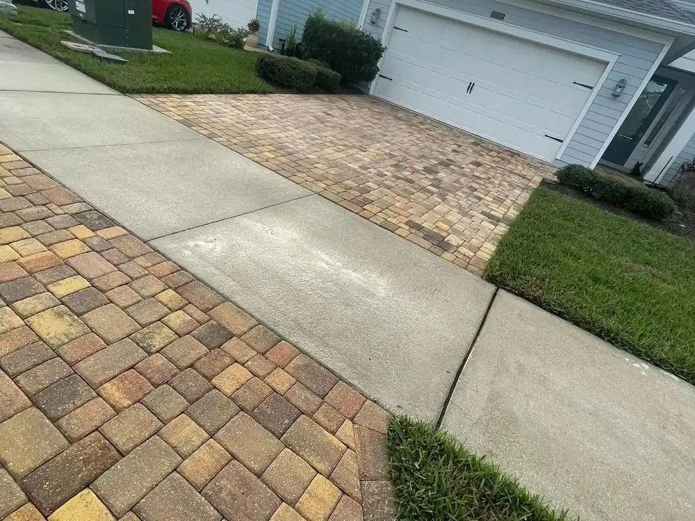 Cleaned paver driveway leading to a residential garage in St. Johns County