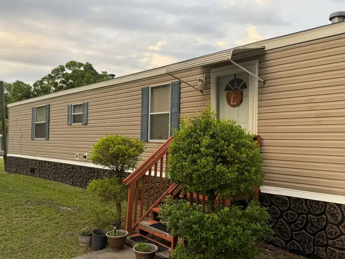 Manufactured home with clean tan siding after a soft wash in St. Johns County